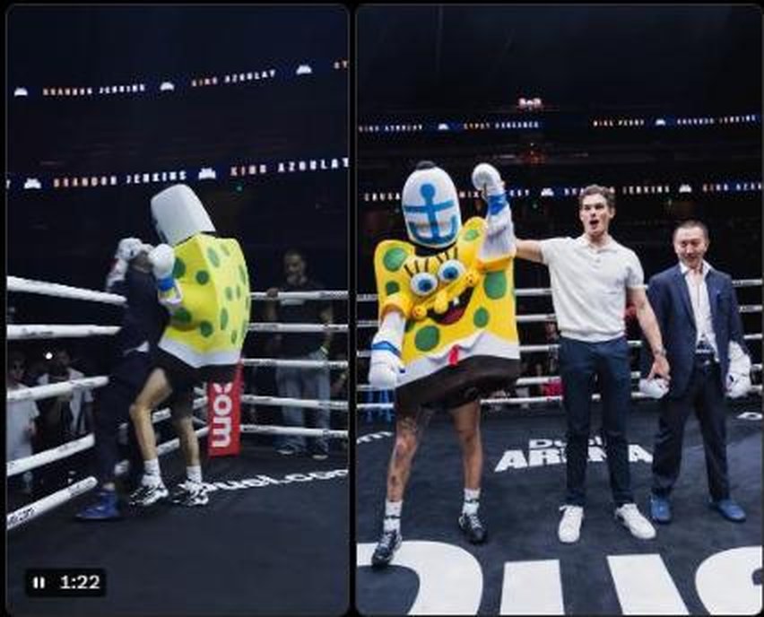 The unrecorded eleventh bout at Duel: Arena 1 — a competitor in a full foam costume trading strikes in the ring, and afterwards having his hand raised by a referee in a polo shirt, jeans and trainers