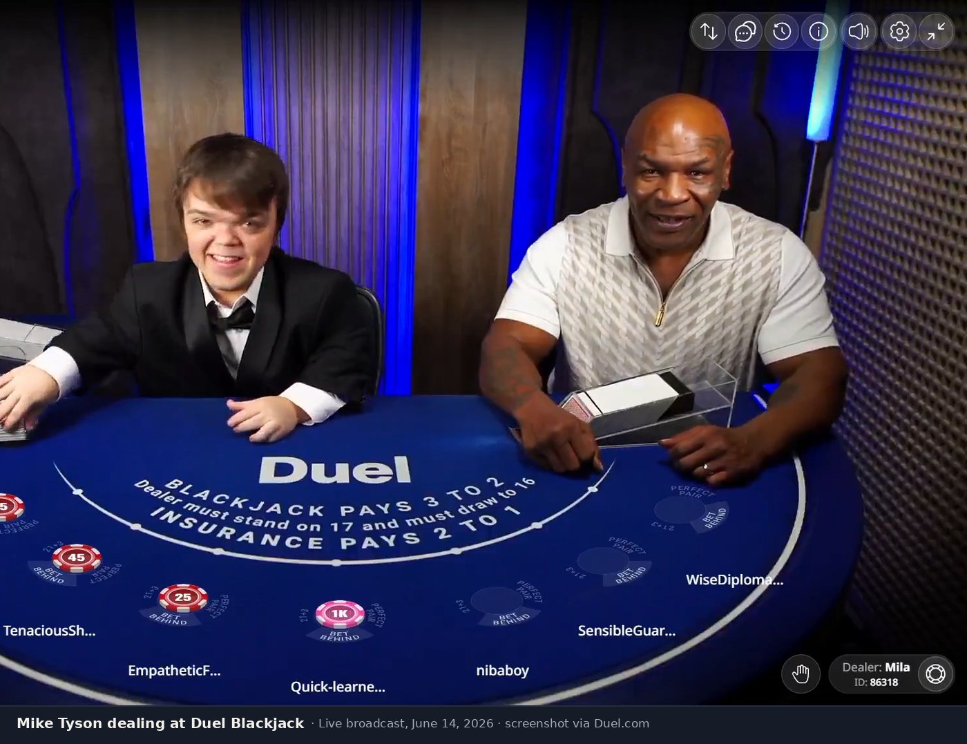 Mike Tyson smiling at the Duel Blackjack table during his live guest dealer appearance